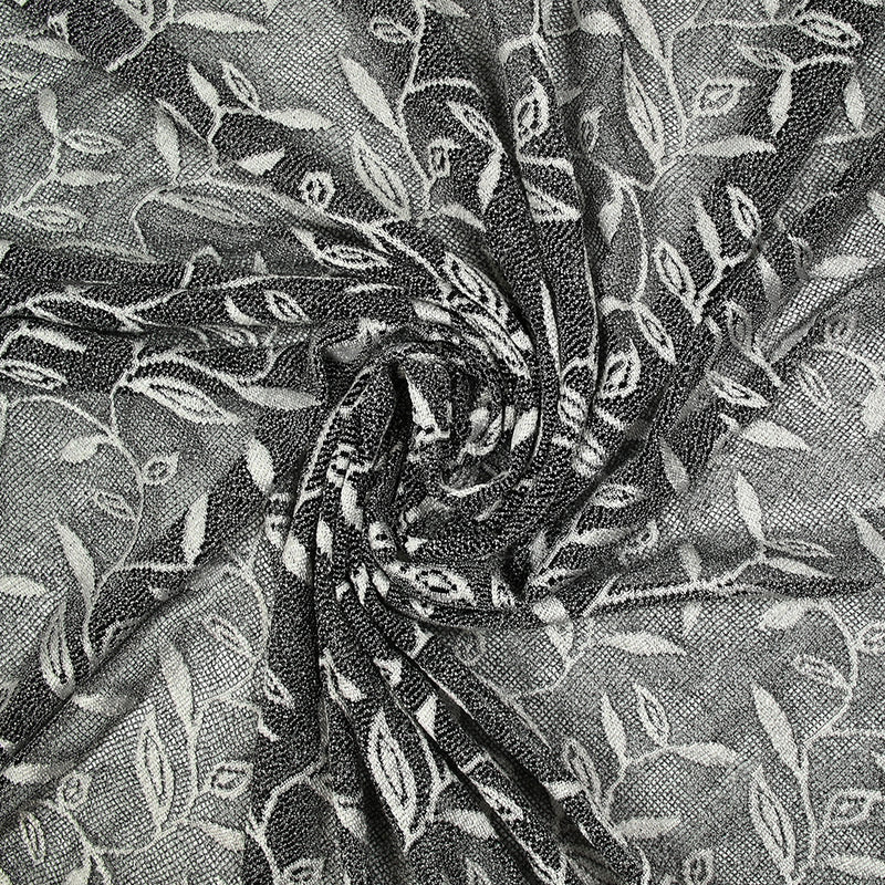 Maille dentelle ajourée motif végétal blanc fond noir