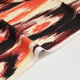 Crêpe viscose imprimée ikat orange fond beige