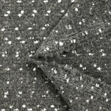 Polyester terry wool and white confetti, gray background