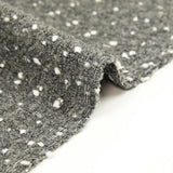 Polyester terry wool and white confetti, gray background