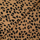 Crêpe satiné de polyester sauvage noire fond mordoré