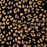 Crêpe satiné de polyester sauvage mordoré fond noir