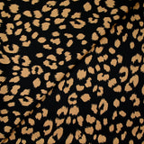 Crêpe satiné de polyester sauvage mordoré fond noir