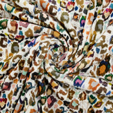 Short-sleeved velvet jersey with multicolored leopard print and white background