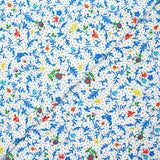 Jersey de viscose satiné imprimé fleurs bleues fond confetti multicolore