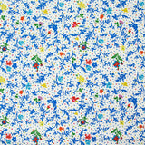 Jersey de viscose satiné imprimé fleurs bleues fond confetti multicolore