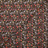 Prado de voile de algodón con estampado digital de pequeñas flores de color naranja y amarillo mantequilla sobre fondo negro