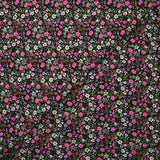 Prado de voile de algodón con estampado digital de pequeñas flores fucsia y verde manzana sobre fondo negro