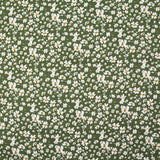 Viscosa estampada con flores blancas y amarillas, fondo caqui.