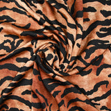 Crêpe satiné de polyester tigre noir fond marron