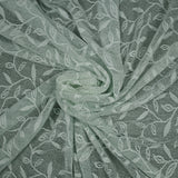 Maille dentelle ajourée motif végétal fond vert d'eau