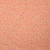 Coton imprimé mini fleurs fond saumon
