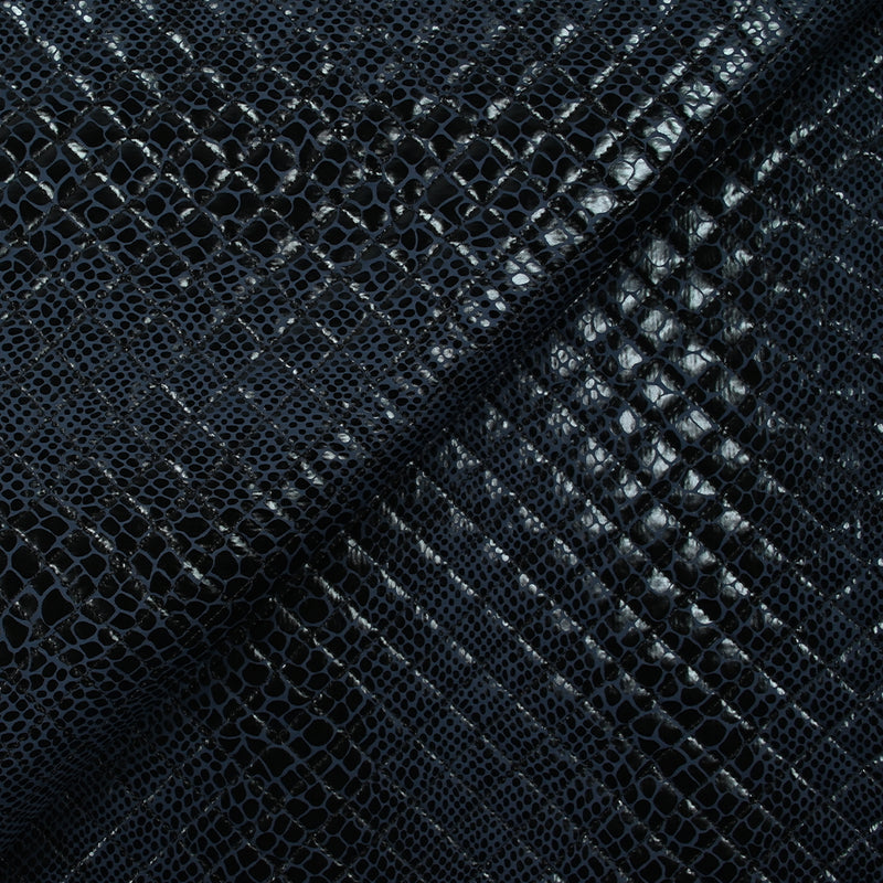 Matelassé imprimé reptile fond bleu marine