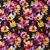 Viscose imprimée danse de fleurs rose et orange fond noir
