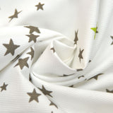 Tissus Piqué de coton imprimé étoiles taupes et vert anis