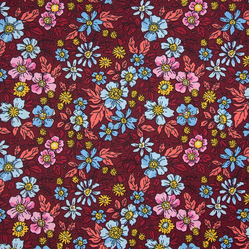 Coton imprimé décor floral sur fond bordeaux