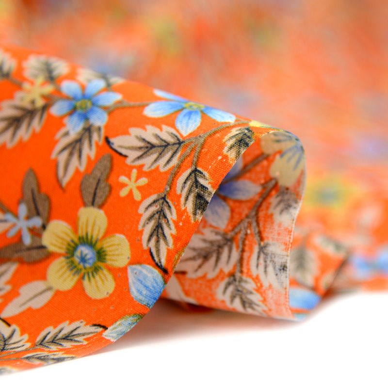 Coton imprimé fleur printanière sur fond orange